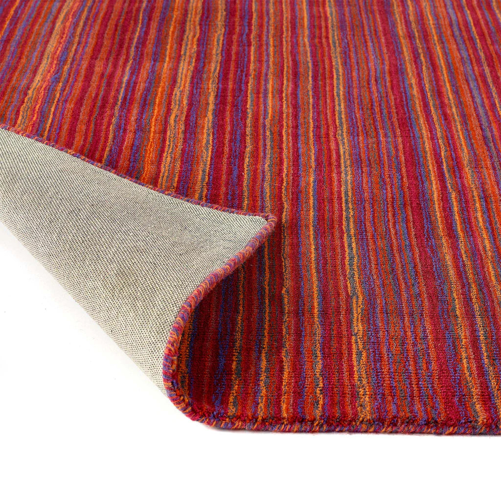 Close-up of a Origins multicolored striped rug with a textured border.