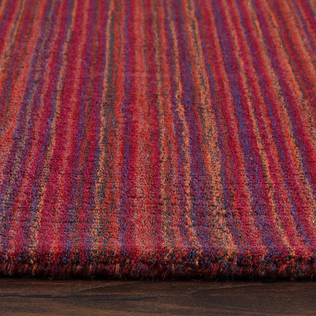 Close-up of a Origins multicolored striped fabric on a wooden surface