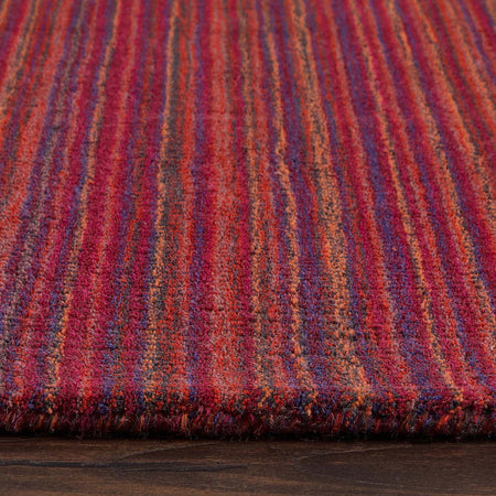Close-up of a Origins multicolored striped fabric on a wooden surface