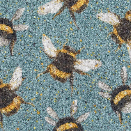 "Close-up of Hug Rug Bee 3 featuring bee and honeycomb pattern on absorbent recycled fabric