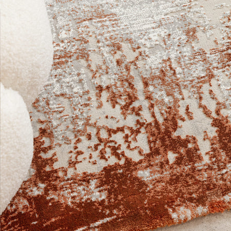Warm terracotta rug with subtle border

