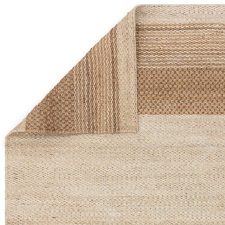 Neutral jute rug styled in minimalist room

