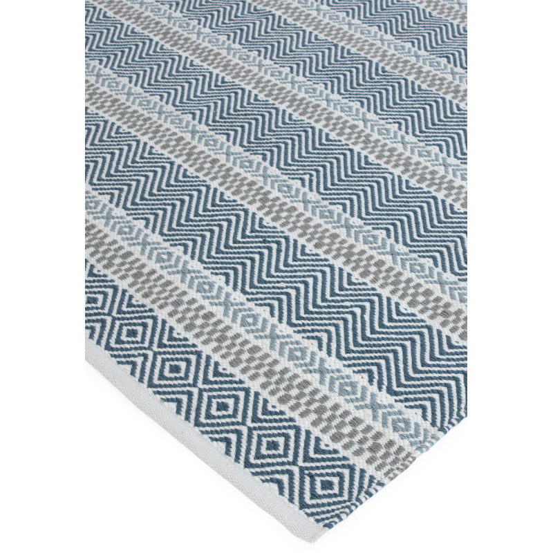 Blue stripe rug styled in garden space

