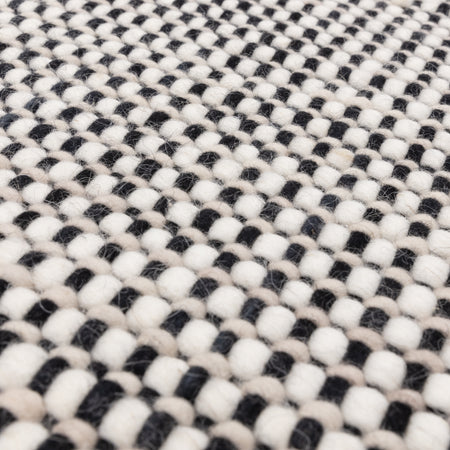 Minimalist Avalon rug on wooden floor

