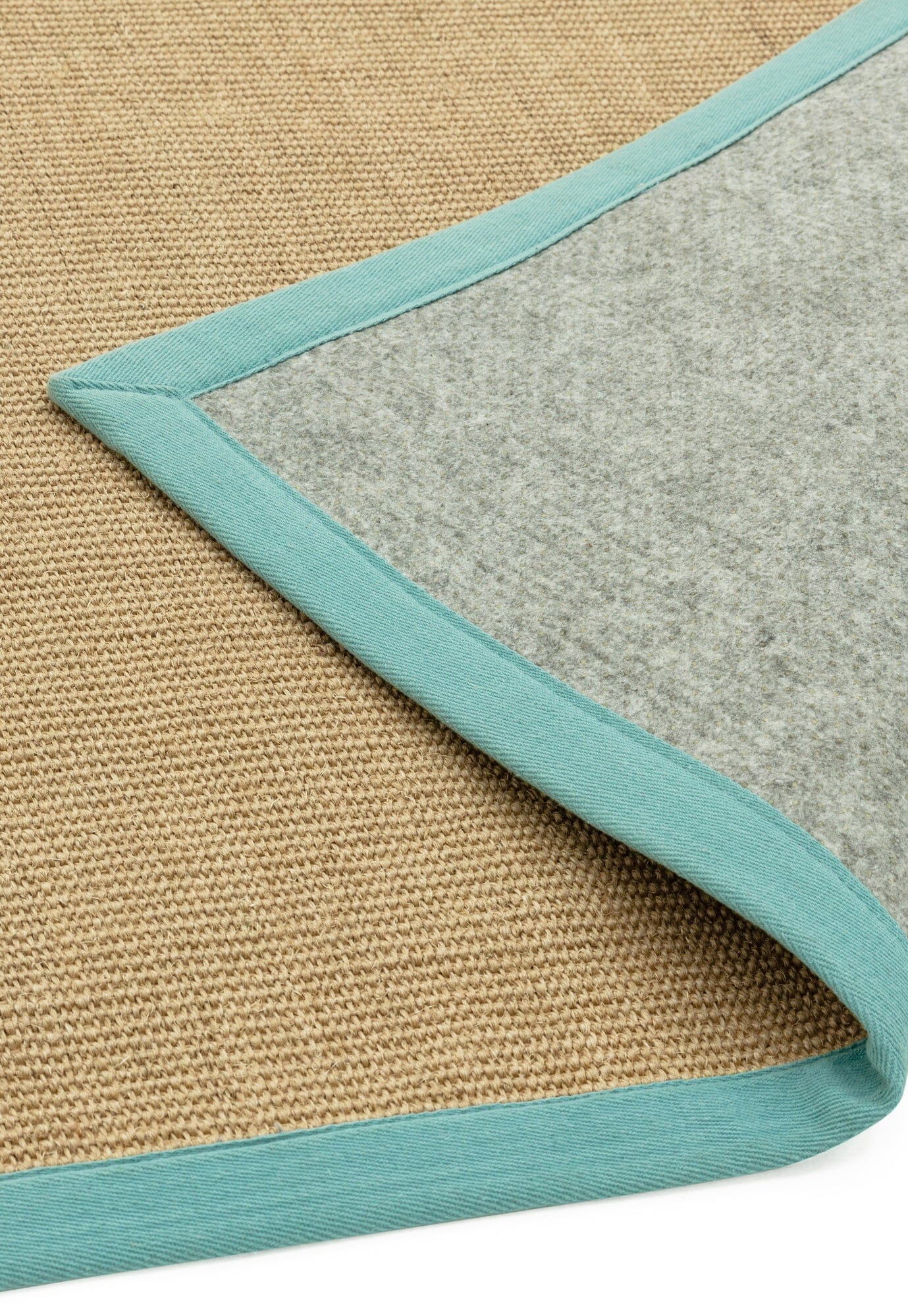 Sisal rug with aqua cotton border showing non slip backing