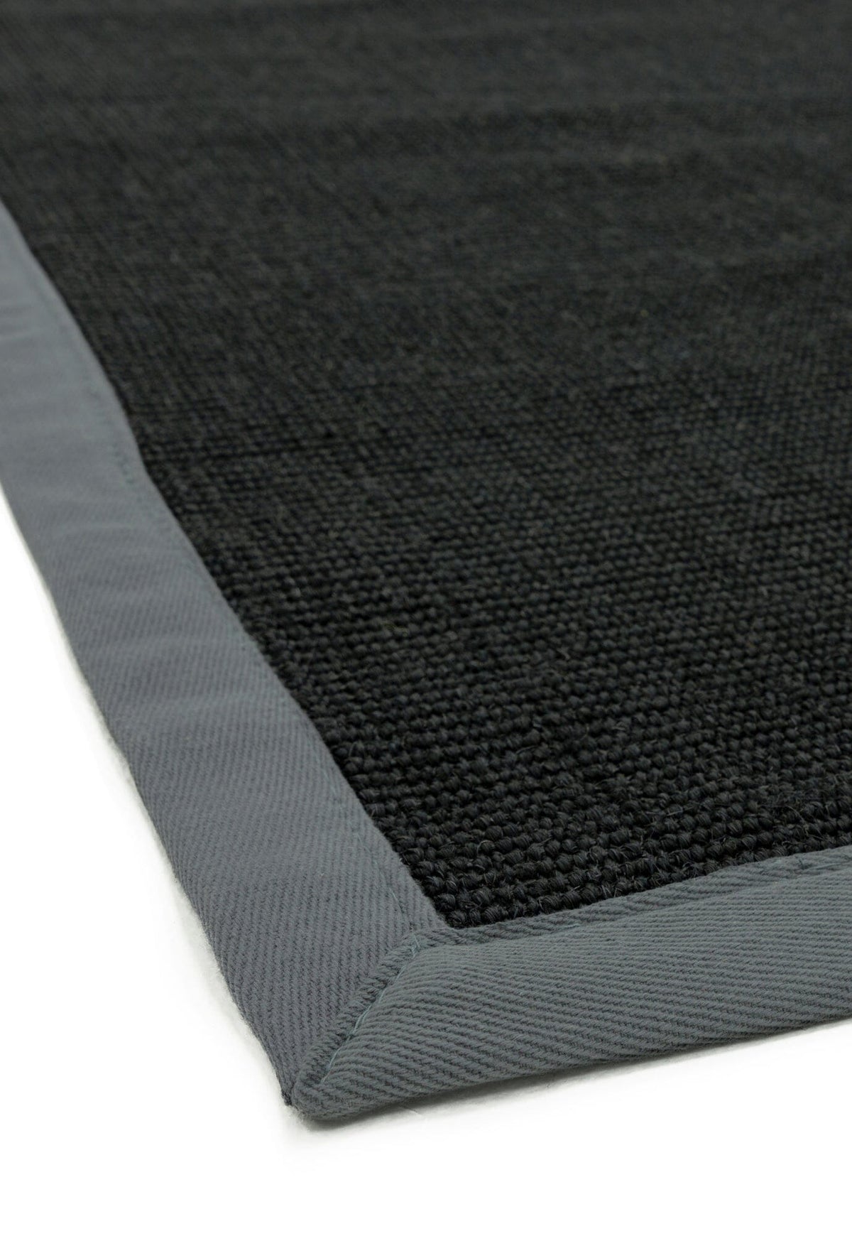Close-up of grey cotton trim on sisal surface