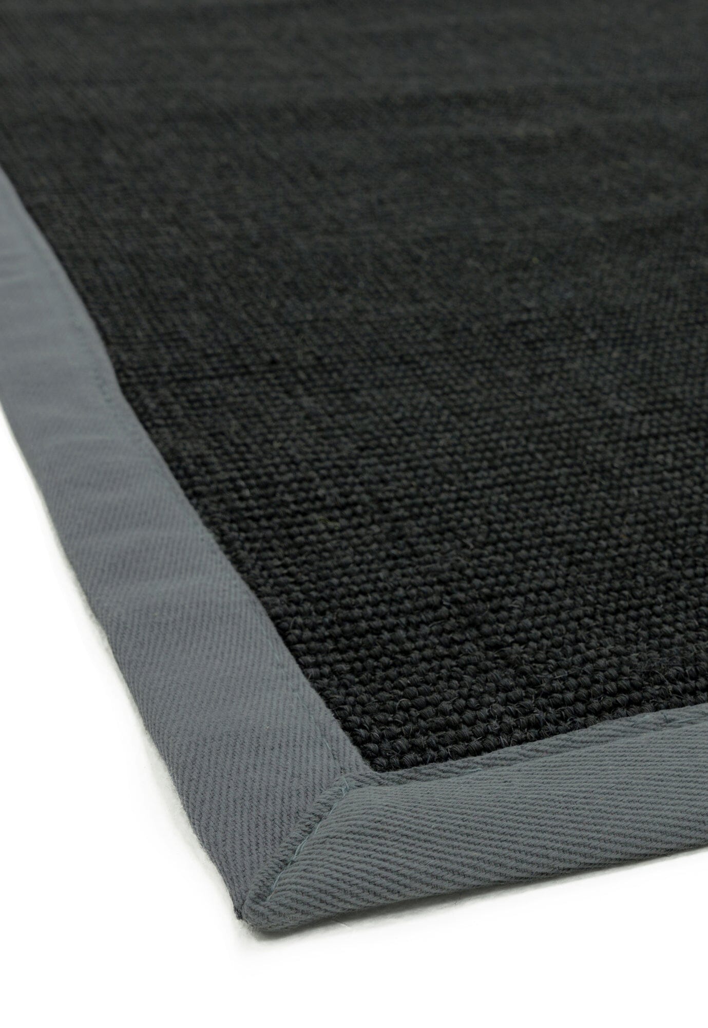 Close-up of grey cotton trim on sisal surface