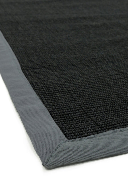 Close-up of grey cotton trim on sisal surface