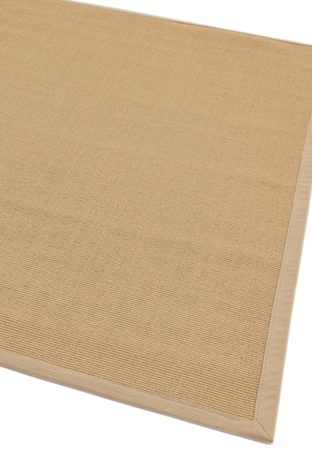 Low-pile beige rug with coordinated cotton trim

