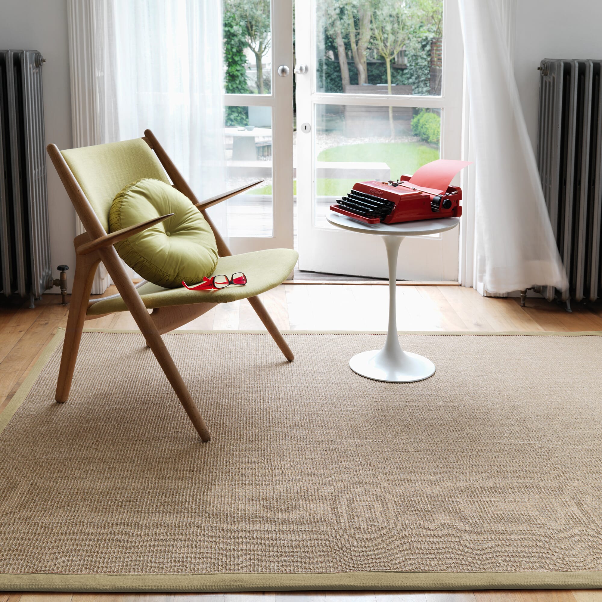 Botanical colour rug on wooden floor

