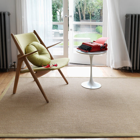 Botanical colour rug on wooden floor


