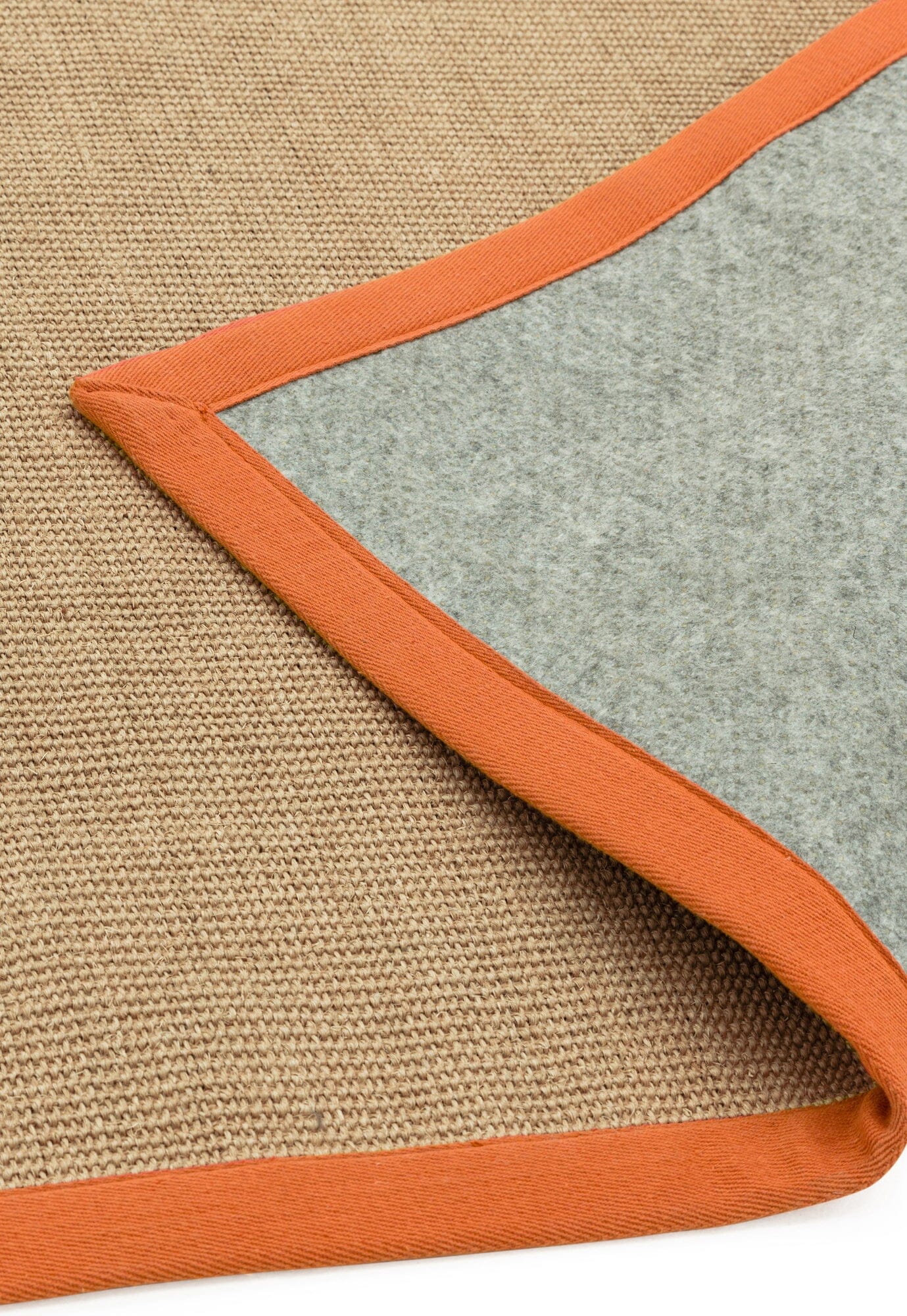 Flatwoven natural rug with colourful trim showing non slip backing