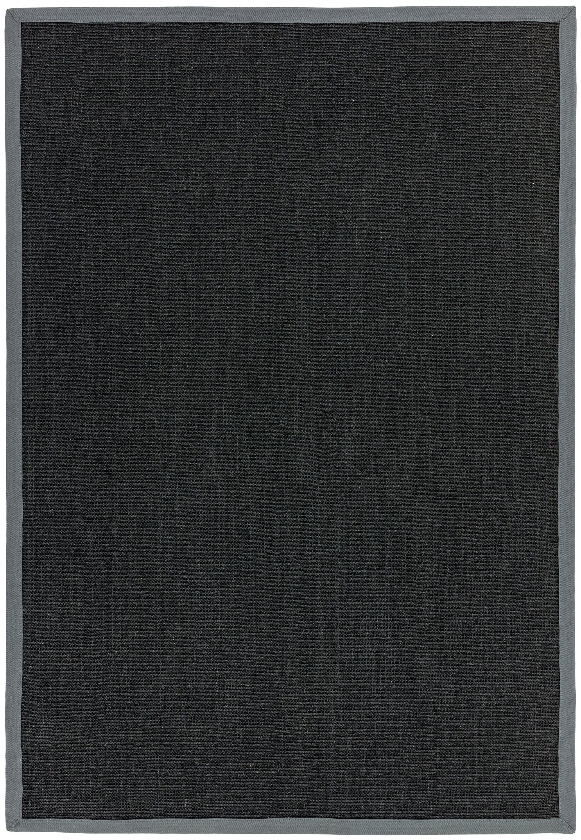 Flatwoven black rug with grey hand-stitched edge